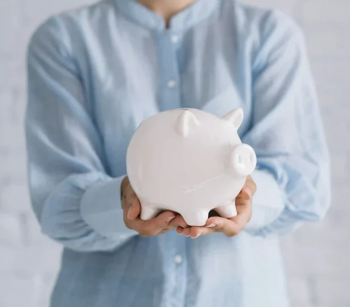 close-up-woman-s-hand-holding-piggybank_3_11zon