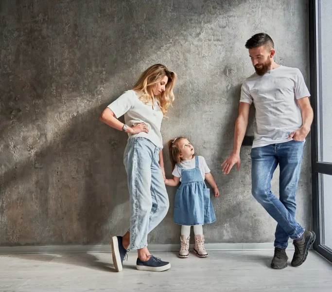 happy-family-standing-by-the-wall-in-new-apartment-2023-11-27-05-22-47-utc_7_11zon