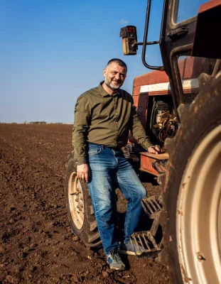 portrait-of-satisfied-farmer-standing-next-to-the-2024-10-29-00-40-41-utc-min-min